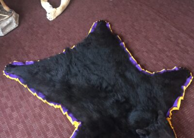 purple and gold bear rug